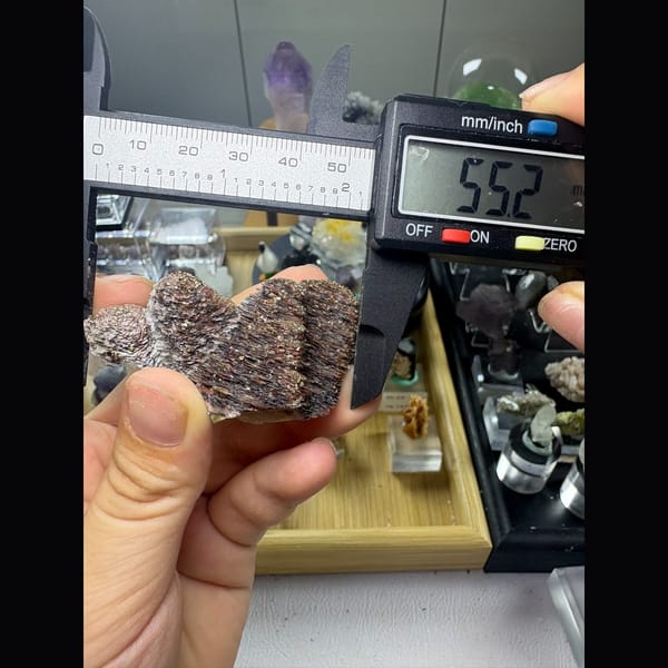 Two stacked towers of bladed calcite with hematite and pyrite — detail view