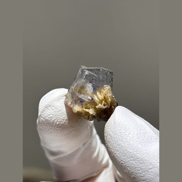 Grey-violet fluorite cube with golden mica from Yaogangxian — complete view