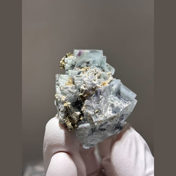 Pale blue porcelain-lustre fluorite cubes with mica from Yaogangxian — alternate view