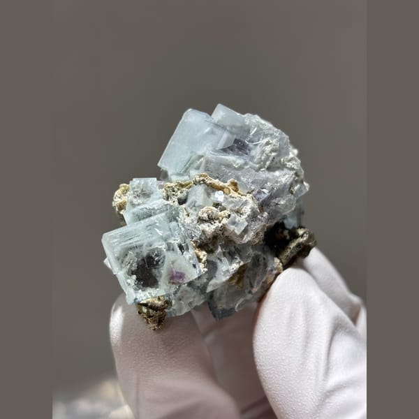 Pale blue porcelain-lustre fluorite cubes with mica from Yaogangxian — alternate view