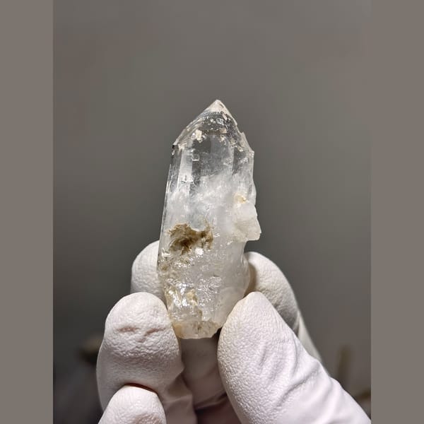 Clear quartz point with intact tip from Xuebaoding — complete view