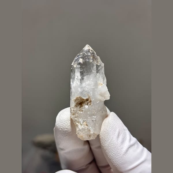Clear quartz point with intact tip from Xuebaoding — alternate view