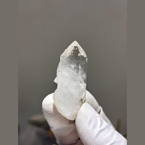 Clear quartz point with intact tip from Xuebaoding — detail view