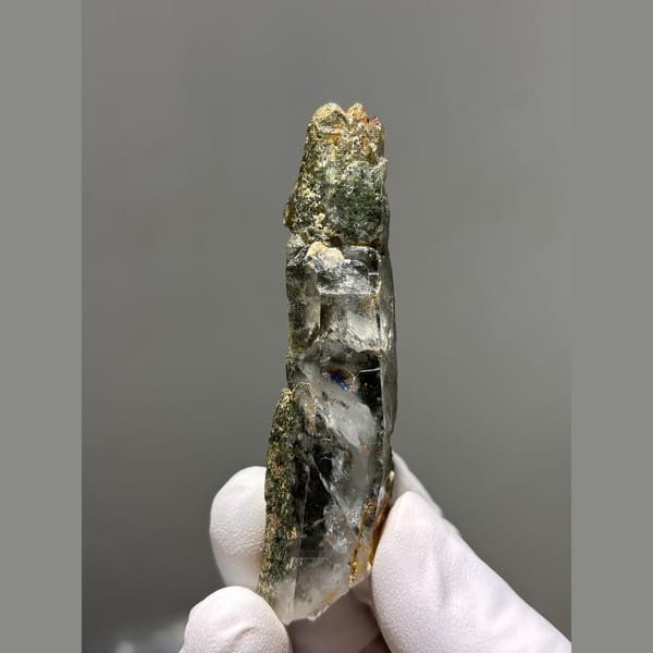 Long quartz crystal coated with green chlorite from Tibet — alternate view