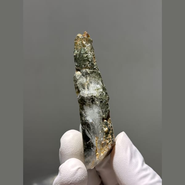 Long quartz crystal coated with green chlorite from Tibet — alternate view