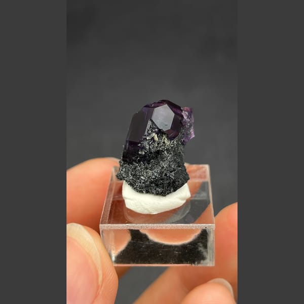 Deep violet-blue fluorite crystal on dark matrix from Fujian — complete view