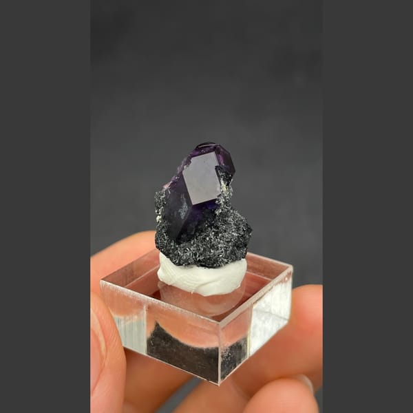 Deep violet-blue fluorite crystal on dark matrix from Fujian — alternate view