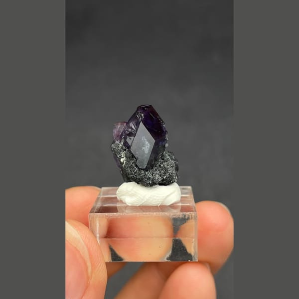 Deep violet-blue fluorite crystal on dark matrix from Fujian — alternate view