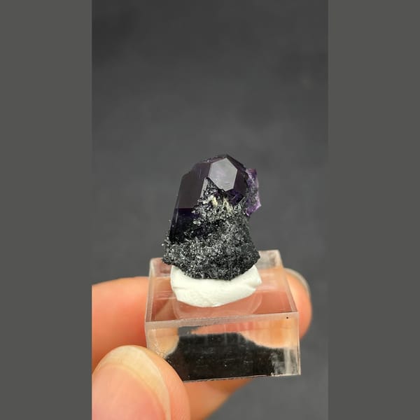 Deep violet-blue fluorite crystal on dark matrix from Fujian — detail view