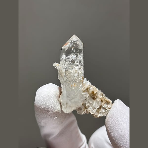 Clear quartz point with silvery mica from Xuebaoding — complete view