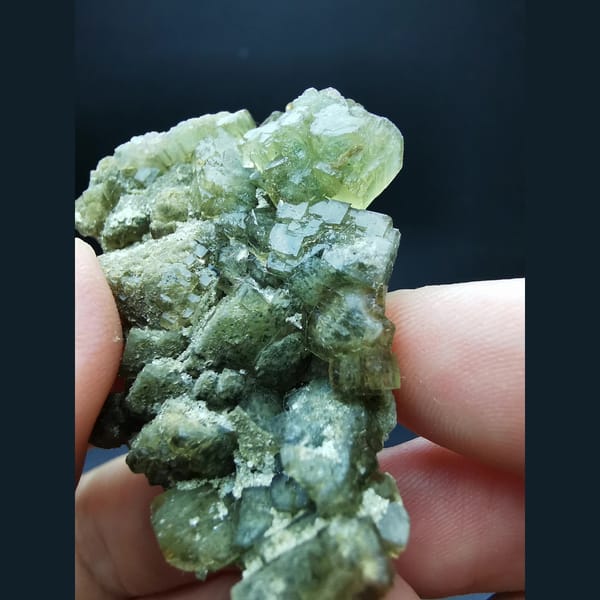 Yellow-green fluorite on calcite plates — detail view
