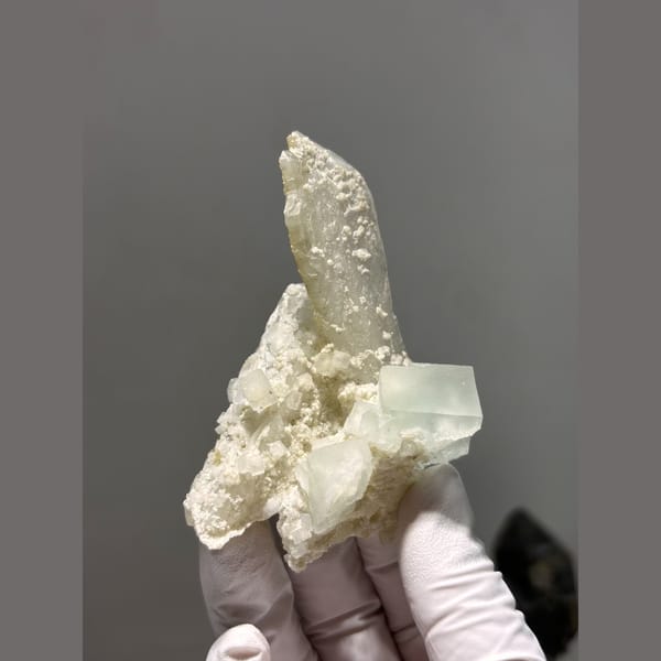 Pale yellow-green fluorite with a quartz point from Daguishan — alternate view