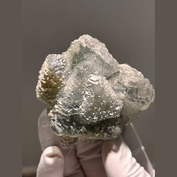 Grey-green fluorite with stepped terraced faces from Hunan — detail view