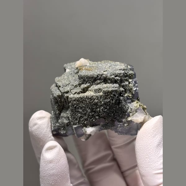 Purple fluorite cube with grey stepped growth from Yaogangxian — detail view