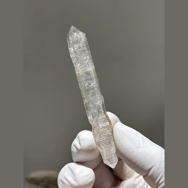 Long slender double terminated quartz crystal from Yunnan — complete view