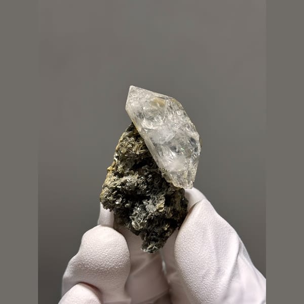 Clear quartz point on mica matrix from Xuebaoding — complete view
