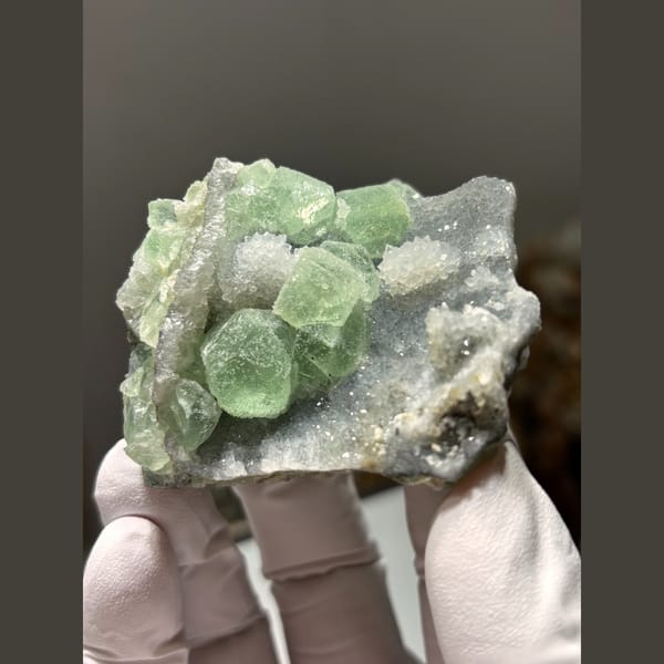 Green fluorite cubes on druzy quartz from Fujian — complete view