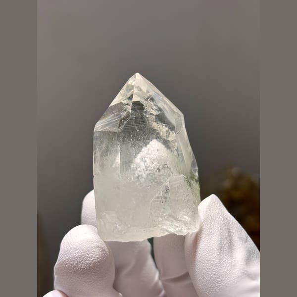 Clear quartz point with white dolomite inclusions from Yaogangxian — complete view