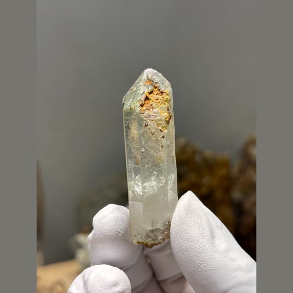 Clear quartz point floater with intact tip from Xuebaoding — detail view
