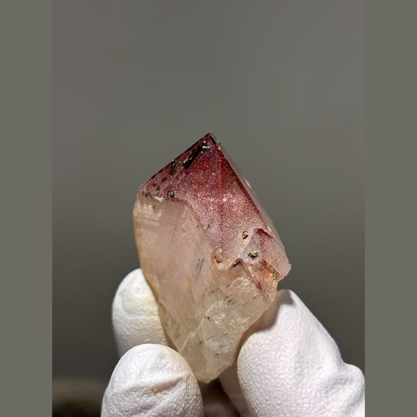 Garden quartz point with pink-red phantom tip from Sichuan — detail view