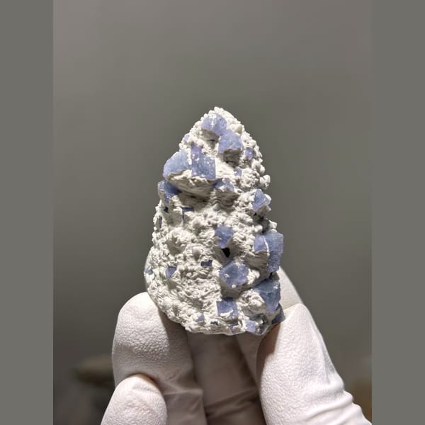 Blue-violet fluorite crystals on white druzy quartz from Inner Mongolia — complete view