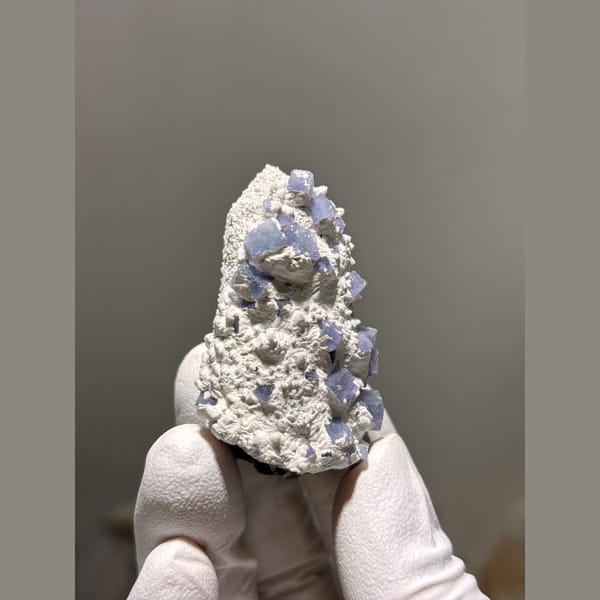 Blue-violet fluorite crystals on white druzy quartz from Inner Mongolia — alternate view