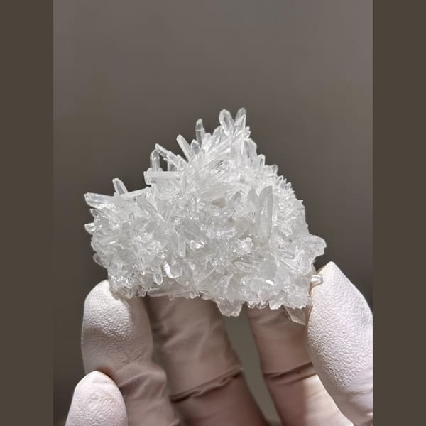 Bright cluster of slender clear quartz points from Jinkouhe — complete view