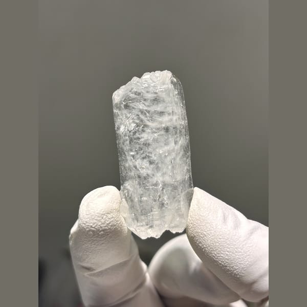 Clear double-terminated quartz floater from Xuebaoding, Sichuan — detail view
