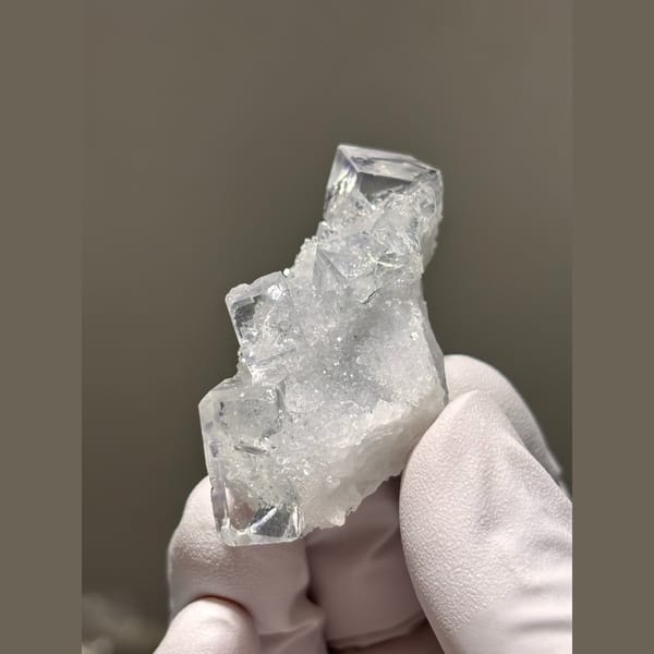 Glassy near-colourless cubic fluorite with quartz from Zhejiang — detail view
