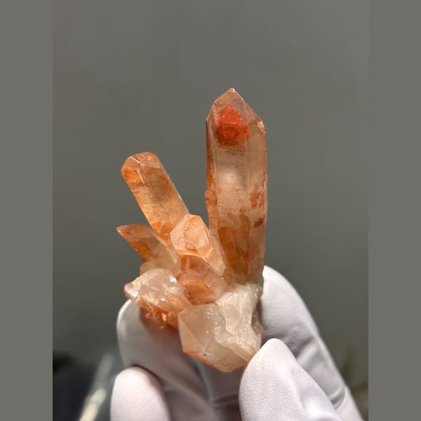 Cluster of orange-red quartz points from Madagascar — complete view