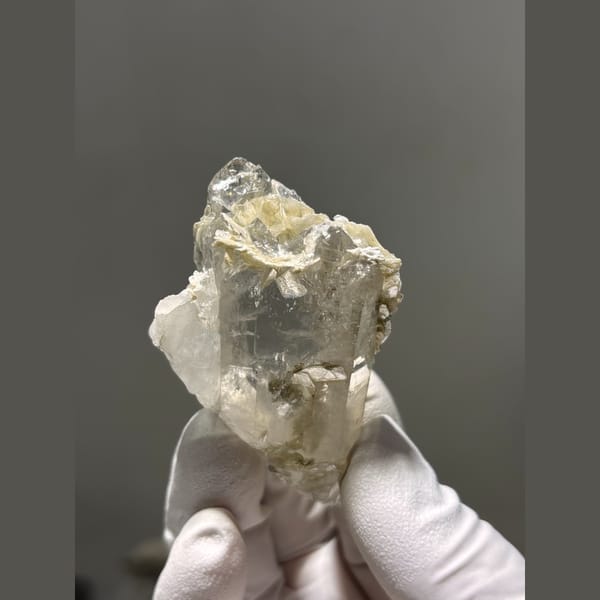Chunky clear quartz crystal with mica from Xuebaoding, Sichuan — detail view