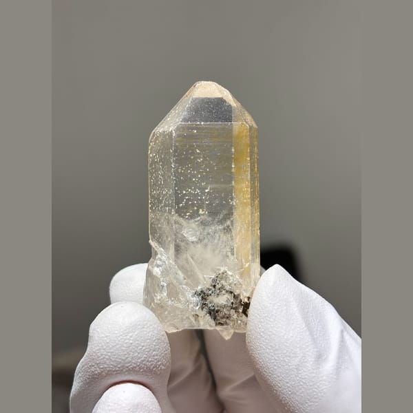 Slim clear to pale yellow quartz point from Xuebaoding, Sichuan — complete view