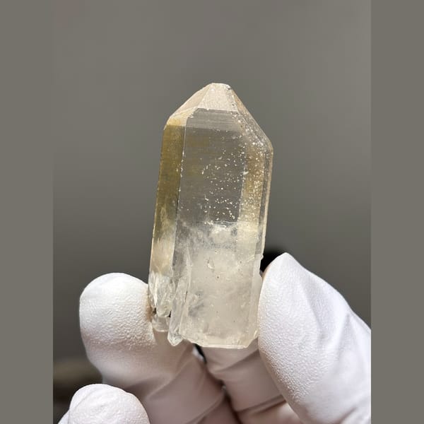 Slim clear to pale yellow quartz point from Xuebaoding, Sichuan — alternate view