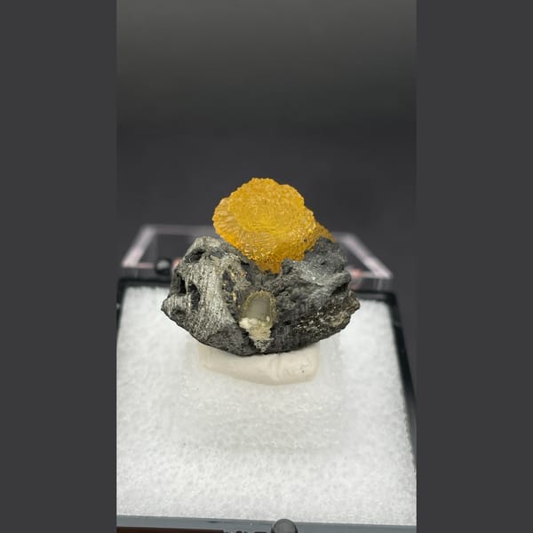 Small amber-brown calcite crystal from Vietnam — complete view
