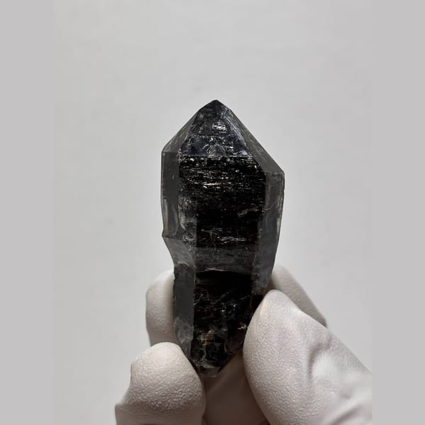 Glossy near-black double-terminated quartz from Yunnan — complete view