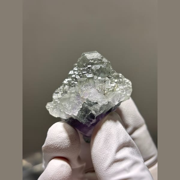 Stepped pale green fluorite with purple base from Fujian — detail view