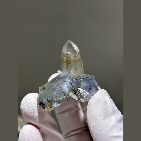 Clear quartz point on blue-grey fluorite from Yaogangxian, Hunan — complete view