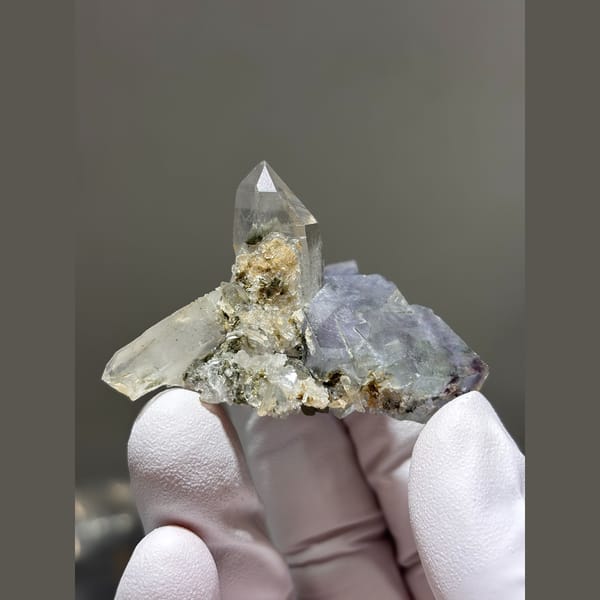 Clear quartz point on blue-grey fluorite from Yaogangxian, Hunan — detail view
