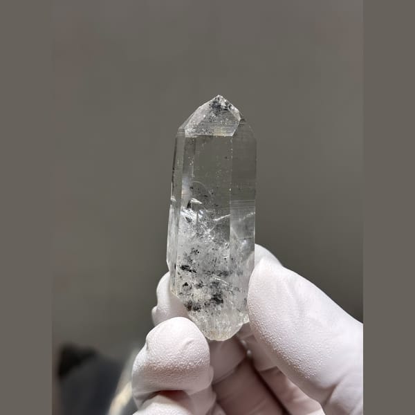 Clear quartz point with internal veils from Jinkouhe, Sichuan — alternate view