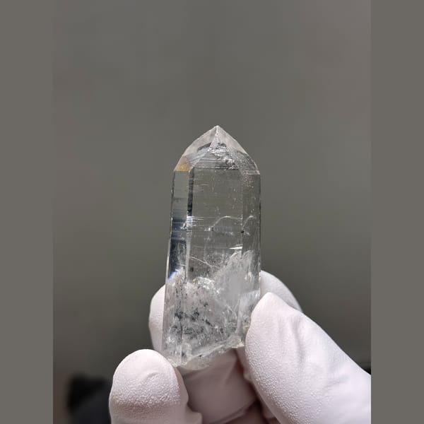 Clear quartz point with internal veils from Jinkouhe, Sichuan — alternate view