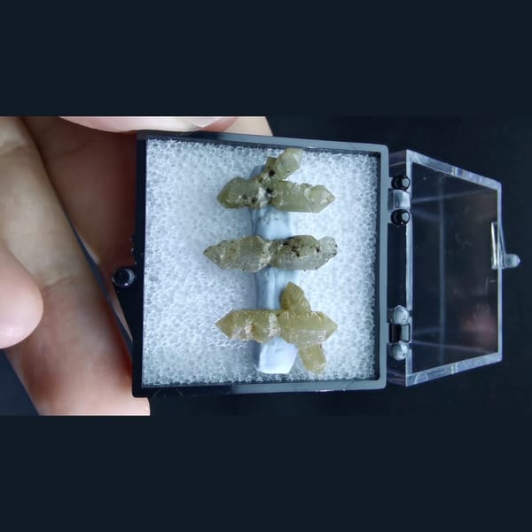 Three double-terminated green quartz crystals — alternate view