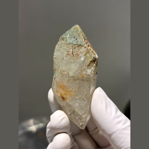 Chunky quartz point with green and rusty inclusions from Tibet — alternate view