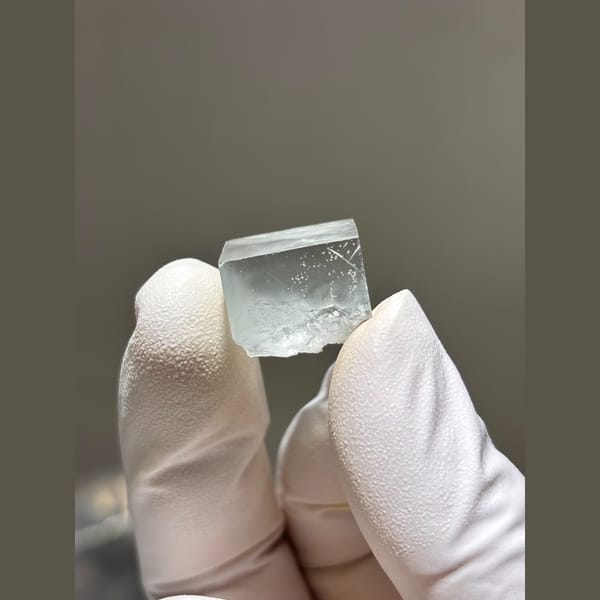 Small glassy pale fluorite cube from Zhejiang — complete view