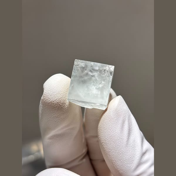Small glassy pale fluorite cube from Zhejiang — alternate view