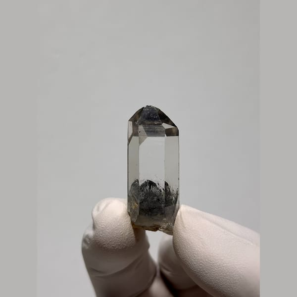 Clear quartz point with a dark inclusion from Jinkouhe — alternate view