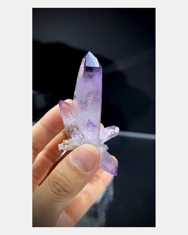Complete left side view of tall purple quartz point
