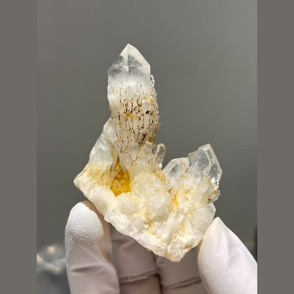 Clear quartz point rising from a crystal cluster from Madagascar — complete view