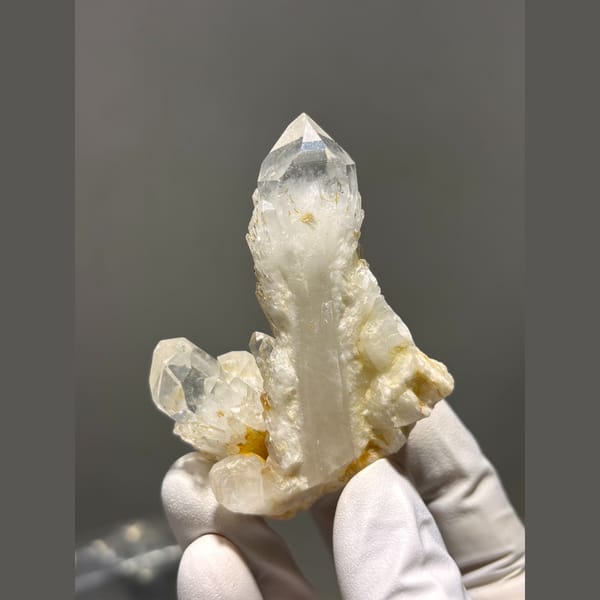 Clear quartz point rising from a crystal cluster from Madagascar — alternate view