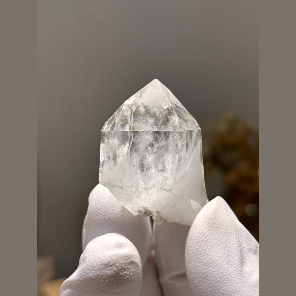 Clear glassy quartz point from Xuebaoding — complete view