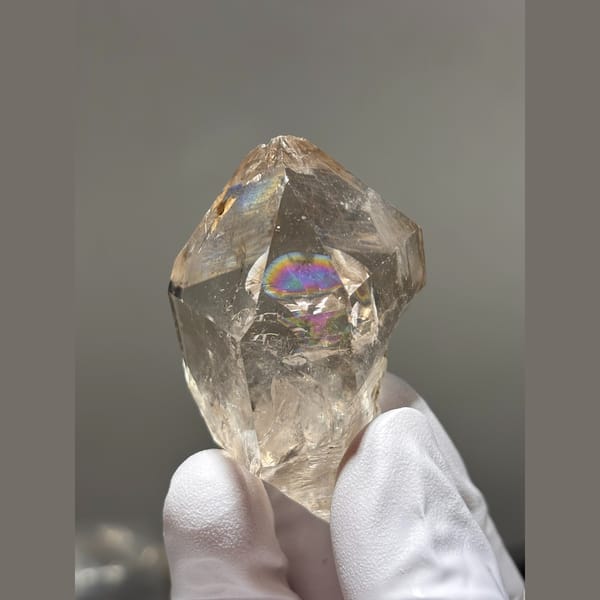 Champagne quartz crystal with internal rainbows from Yunnan — complete view